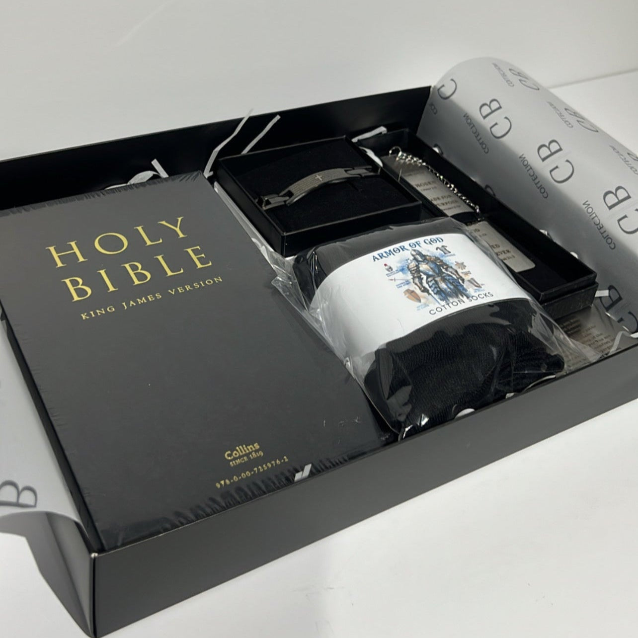 Bible set with black cover and white pages in a box on a light gray background