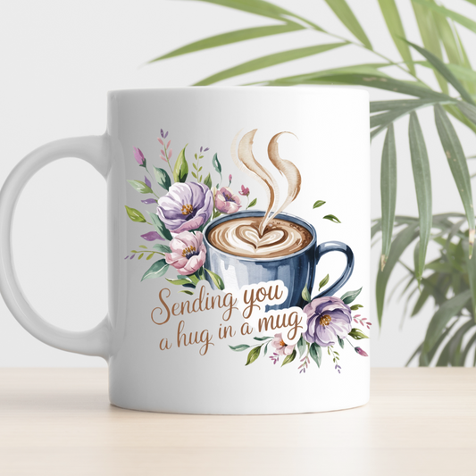 Mug with coffee design and text 'Sending you a hug in a mug' on a white background